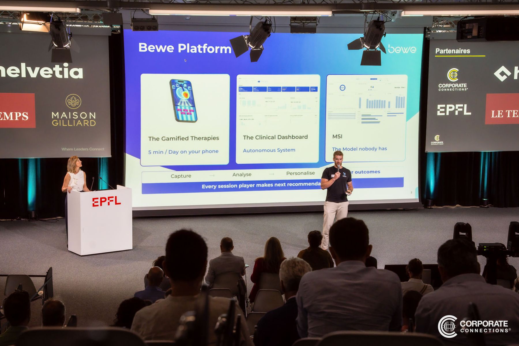 Barnabé Delarze presenting on stage at EPFL